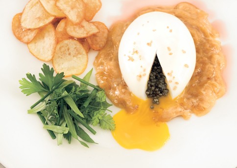 Soft-cooked eggs with onion soubise, caviar, and potato chips