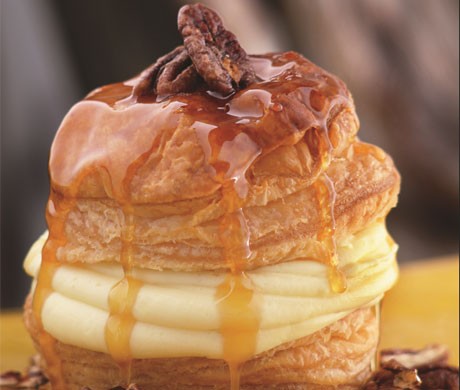 Soufflé of puff pastry with orange-scented pastry cream, candied pecans, and caramel butter sauce