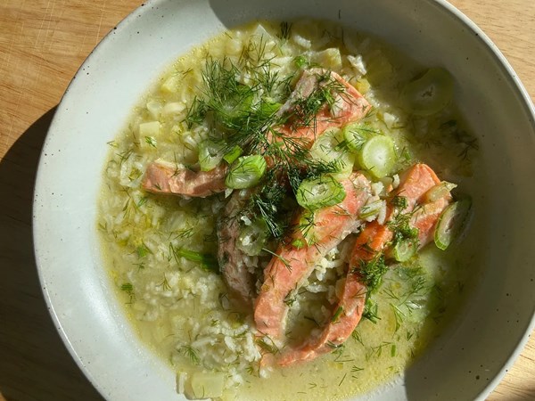 Soupy rice with salmon and dill