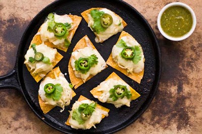 Sour cream chicken nachos with poblano salsa verde
