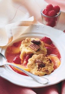 Southern-style peach and raspberry cobbler with pecan-crunch topping