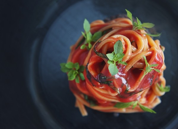 Spaghetti alla chitarra with plum tomato sauce, olive paté and basil