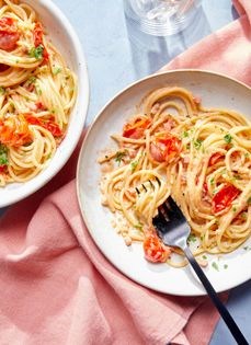Spaghetti with burst cherry tomatoes, pancetta, and feta