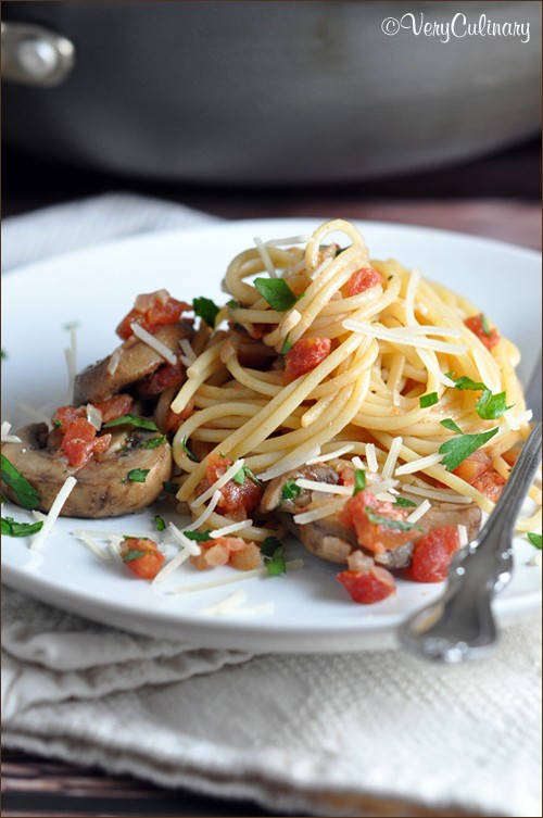 Spaghetti with mushrooms, tomatoes, and Parmesan