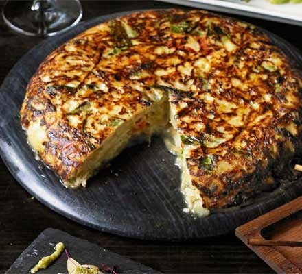 Spanish tortilla with melting goat's cheese, peppers and spinach