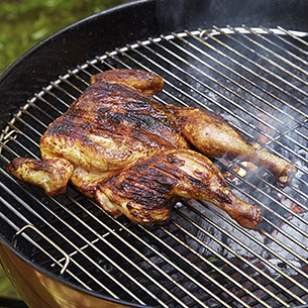 Spatchcocked chicken under a brick