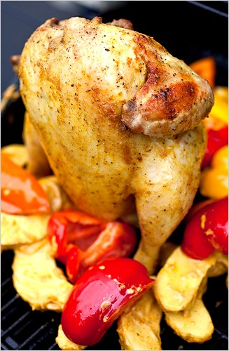 Spice-rubbed beer-can chicken with potatoes and sweet peppers