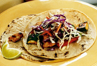 Spice-rubbed chicken and vegetable tacos with cilantro slaw and chipotle cream