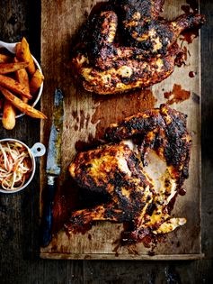 Spice-rubbed, roasted half chicken with smoky bacon chips