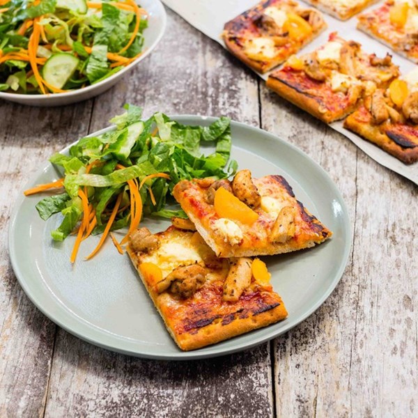 Spiced chicken, apricot and cream cheese pizzas with salad
