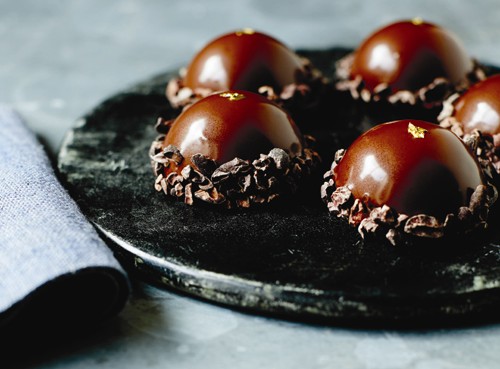Spiced chocolate domes with brandy-soaked raisins and cacao nibs