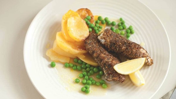 Spiced fish on saffron braised potatoes with peas