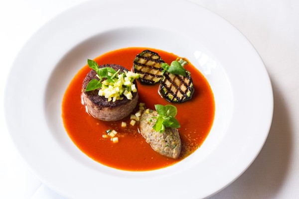 Spiced goat leg with tomato fondue, aubergine purée and courgette
