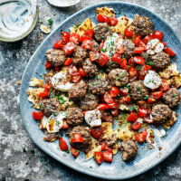 Spiced koftas with grilled flatbread and tomato-zaatar dressing
