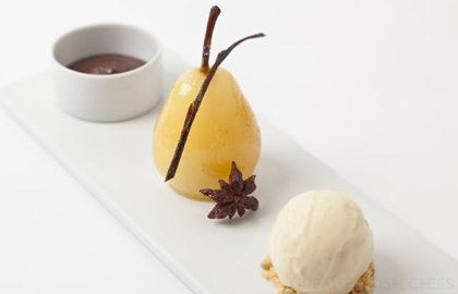 Spiced poached pears with hot chocolate sauce and vanilla ice cream