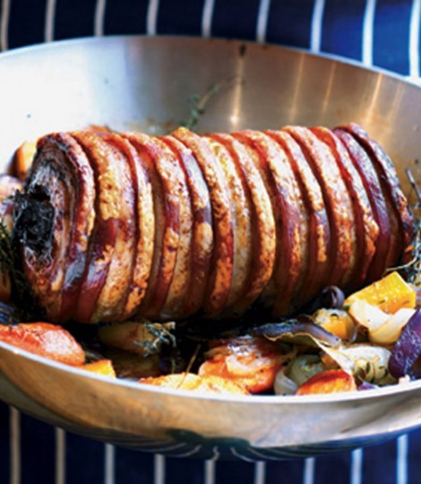 Spiced pork belly stuffed with prunes, with roasted vegetables and cabbage
