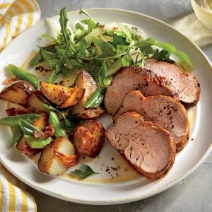 Spiced pork tenderloin with roasted potatoes and green onions