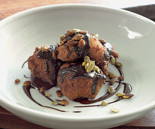 Spiced "pumpkin" fritters with chocolate sauce and candied pepitas