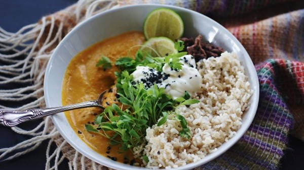 Spiced pumpkin soup with brown rice, black beans and lime whipped feta
