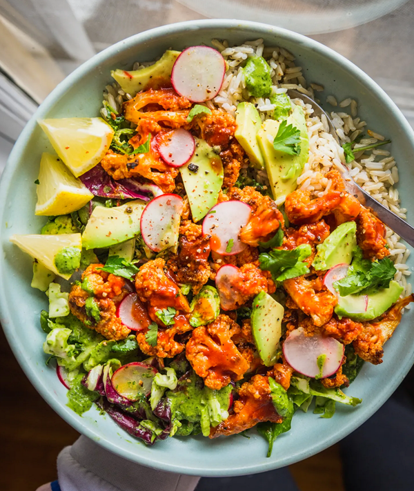 Spicy Buffalo cauliflower bowls with avocado and green tahini