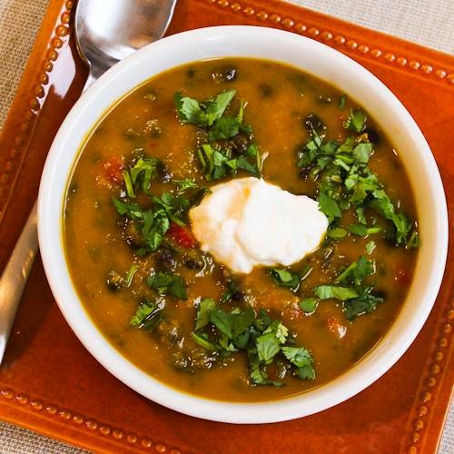 Spicy butternut squash soup with black beans, red bell pepper, and cilantro
