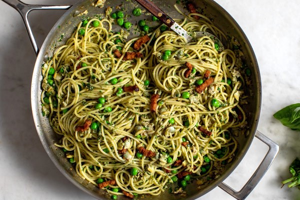 Spicy clam pasta with bacon, peas and basil
