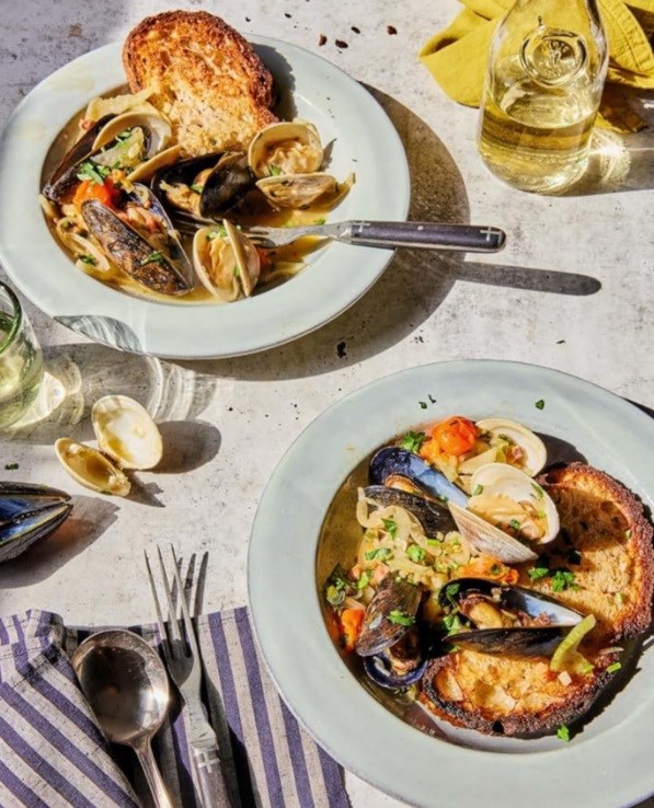 Spicy clams & mussels with pancetta over toast 