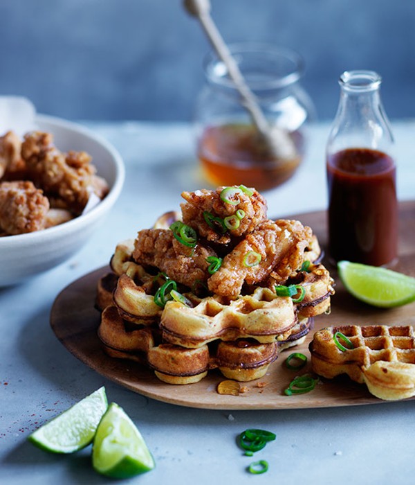 Spicy cornmeal waffles with popcorn chicken, honey and hot sauce