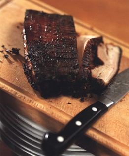Spicy grilled pork belly on Chinese greens
