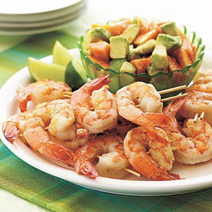 Spicy grilled shrimp kebabs with avocado and papaya salad