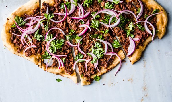 Spicy lamb pizza with parsley–red onion salad