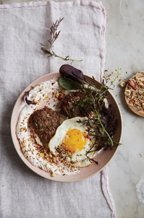 Spicy lamb sausage with yogurt, herbs, and fried egg