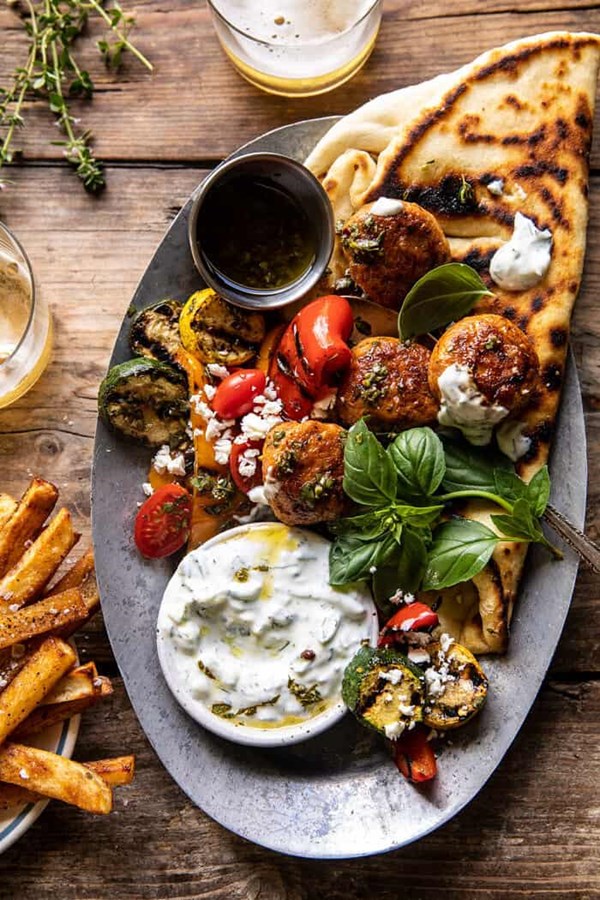 Spicy oregano meatballs with grilled vegetables and tzatziki