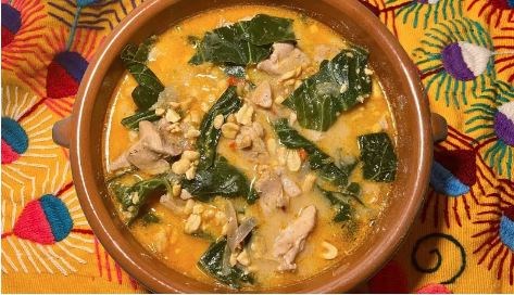Spicy peanut soup with chicken and collards