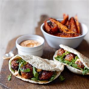 Spicy pork-meatball pittas with harissa mayo and sweet potato wedges