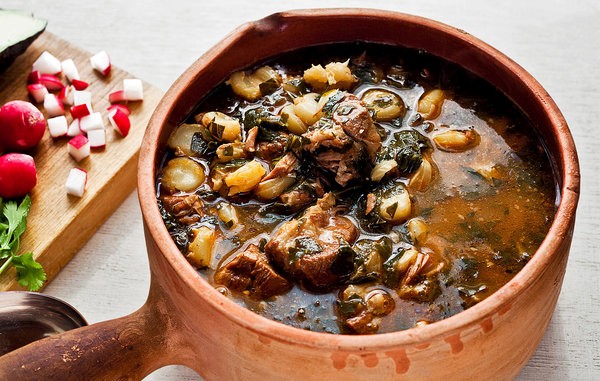 Spicy pork stew with hominy and collard greens
