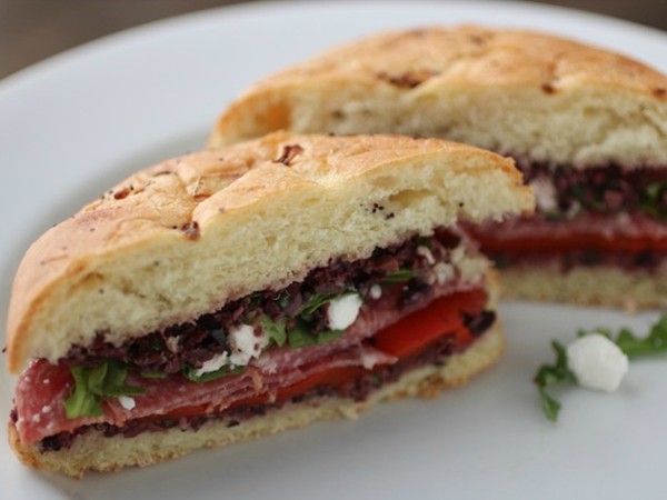 Spicy salami sandwich with olive tapenade and goat cheese