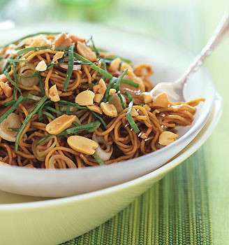 Spicy sesame noodles with chopped peanuts and Thai basil