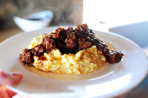 Spicy stewed beef with creamy cheddar grits