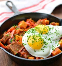 Spicy tomato and burnt-ends hash with fried eggs