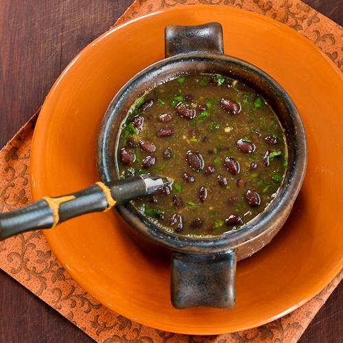 Spicy vegan black bean soup with cilantro and green tabasco