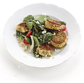 Spinach and artichoke salad with couscous cakes and feta