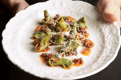 Spinach cappellacci with goat ragù and broccoli rabe