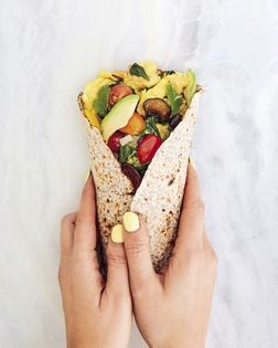 Spinach, mushroom, and egg breakfast burrito with avocado