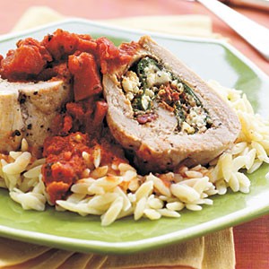 Spinach, pesto, and feta-stuffed pork tenderloin with chunky tomato sauce