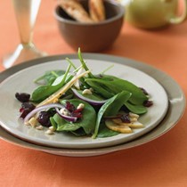 Spinach salad with Bosc pears, cranberries, red onion, and toasted hazelnuts