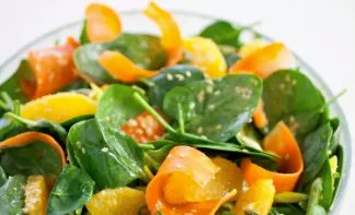 Spinach salad with carrots, oranges, and sesame