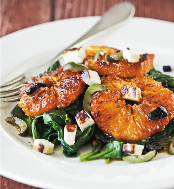 Spinach salad with charred ricotta salata and caramelized oranges