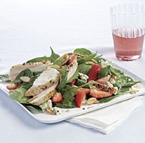 Spinach salad with chicken, strawberries, blue cheese, and almonds