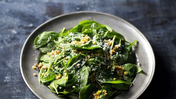 Spinach salad with goat cheese, spicy cashews, and corn vinaigrette
